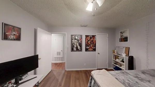 a bedroom with a bed and a flat screen tv