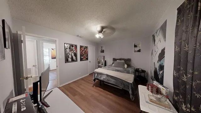 a bed room with a bed and a flat tv screen