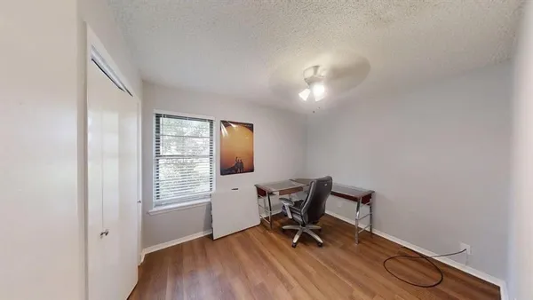 a view of a workspace with furniture and a window