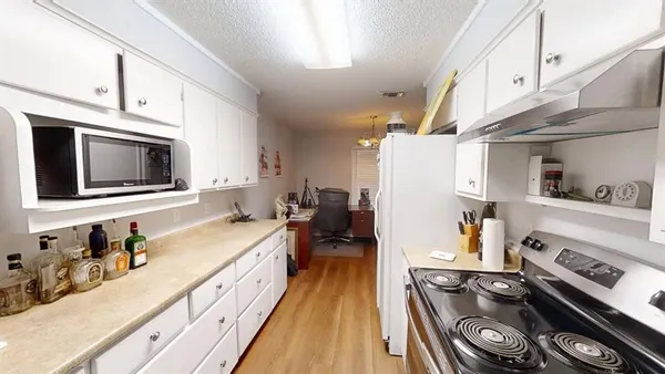 a kitchen with stainless steel appliances a stove a sink and a microwave
