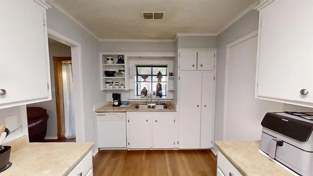 a kitchen with granite countertop a stove and a refrigerator