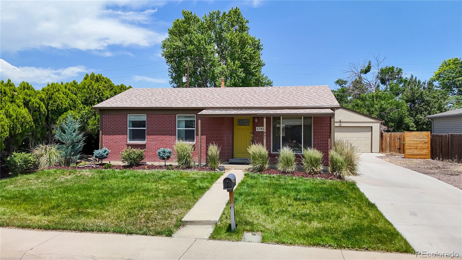 a front view of a house with a yard and porch