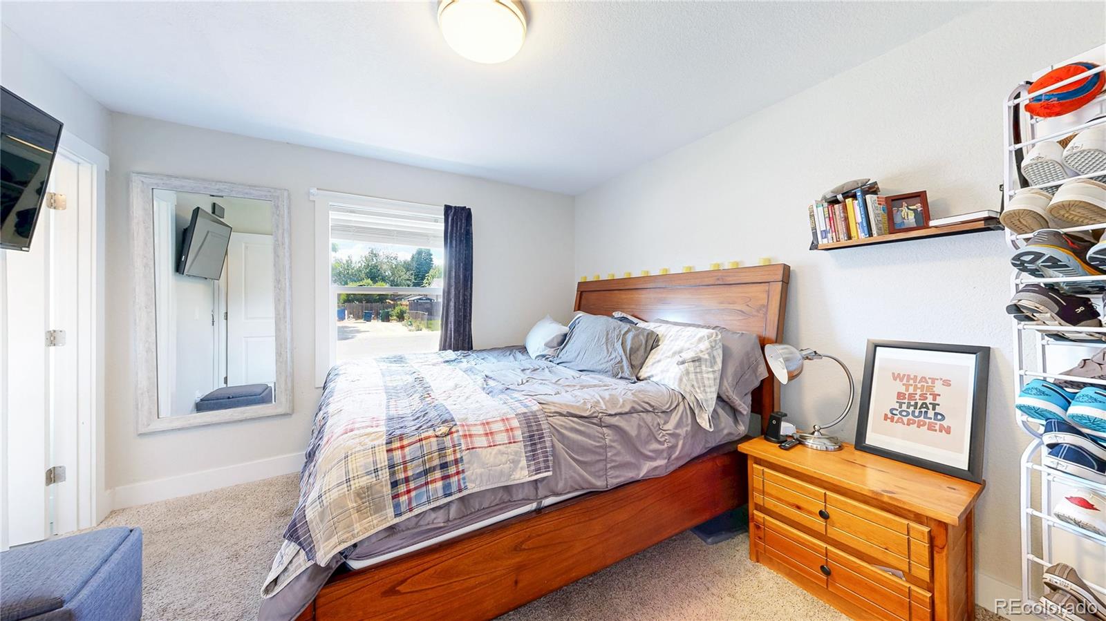 1741 West 55th Place Denver, CO 80221 - Photo 12 of 36 a bedroom with a bed and a window