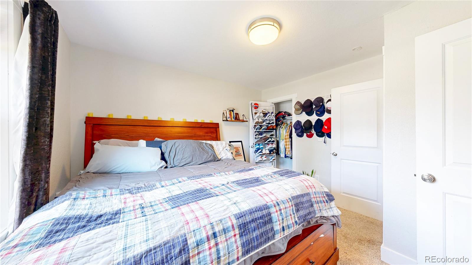 1741 West 55th Place Denver, CO 80221 - Photo 13 of 36 a bedroom with a bed and a closet