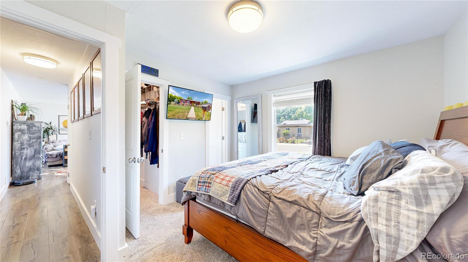 1741 West 55th Place Denver, CO 80221 - Photo 14 of 36 a bedroom with a bed and a window