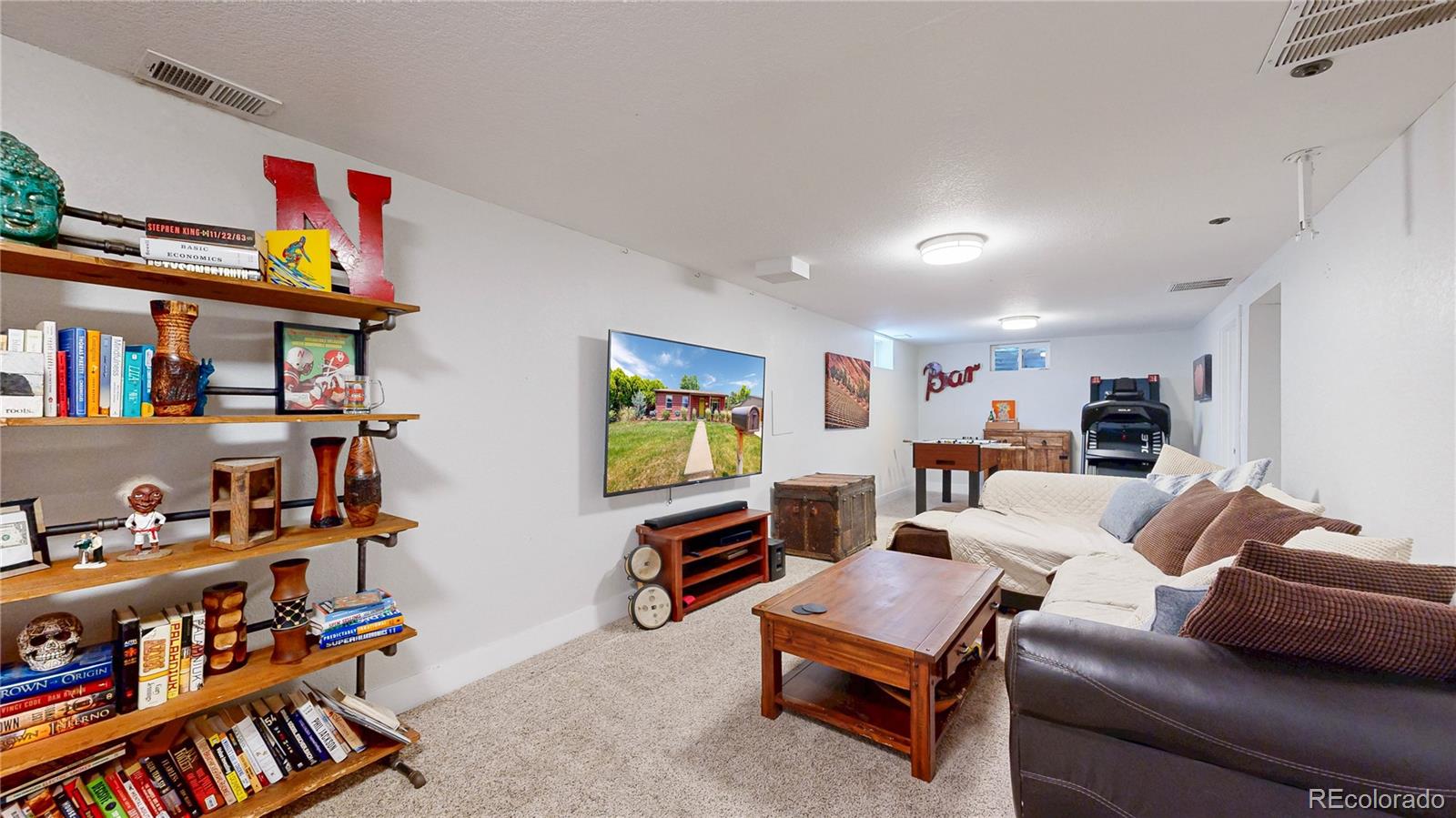 1741 West 55th Place Denver, CO 80221 - Photo 16 of 36 a living room with furniture cabinets and a book shelf