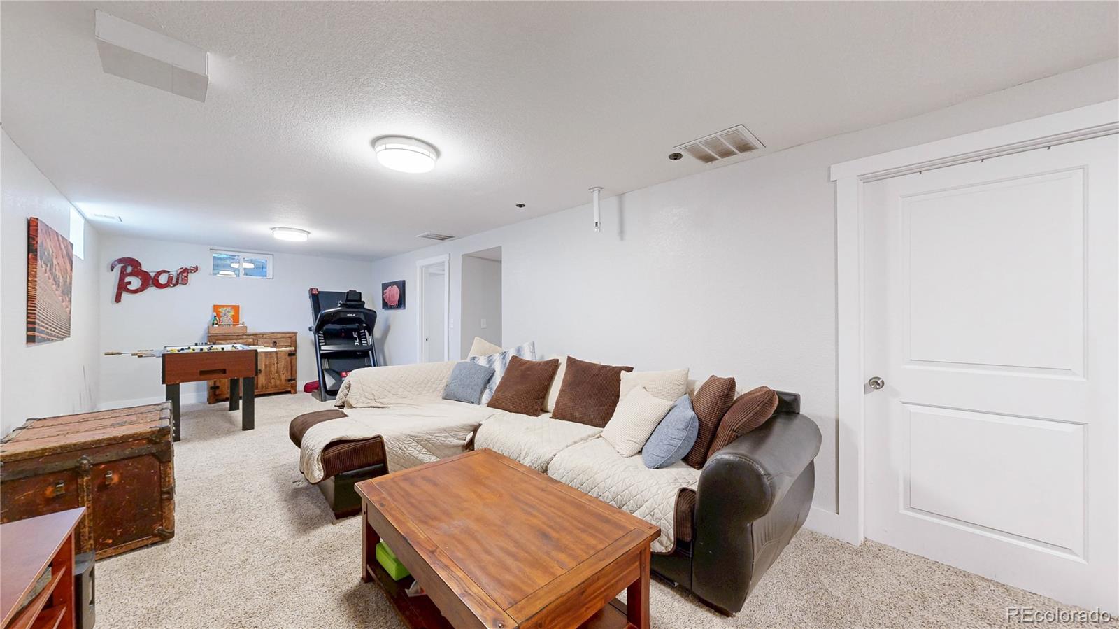 1741 West 55th Place Denver, CO 80221 - Photo 17 of 36 a living room with furniture a ceiling fan and a rug