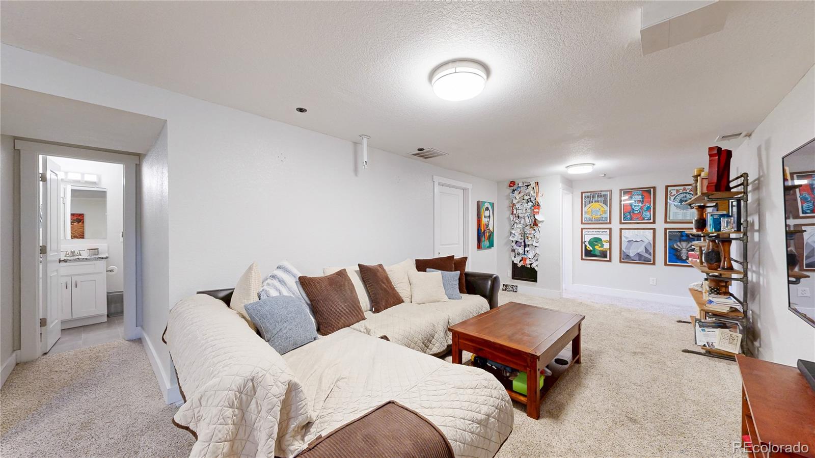 1741 West 55th Place Denver, CO 80221 - Photo 18 of 36 a living room with furniture and gym equipment