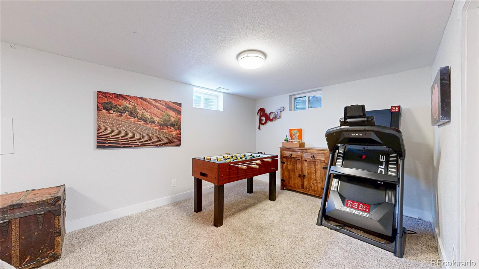 1741 West 55th Place Denver, CO 80221 - Photo 20 of 36 a bedroom with furniture and a book shelf