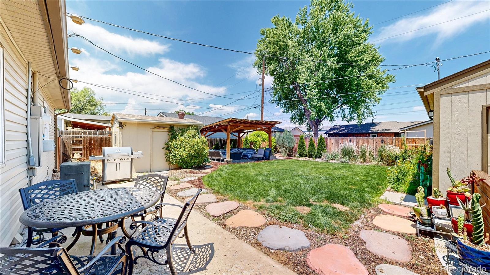 1741 West 55th Place Denver, CO 80221 - Photo 25 of 36 a view of a chairs and table in backyard of the house