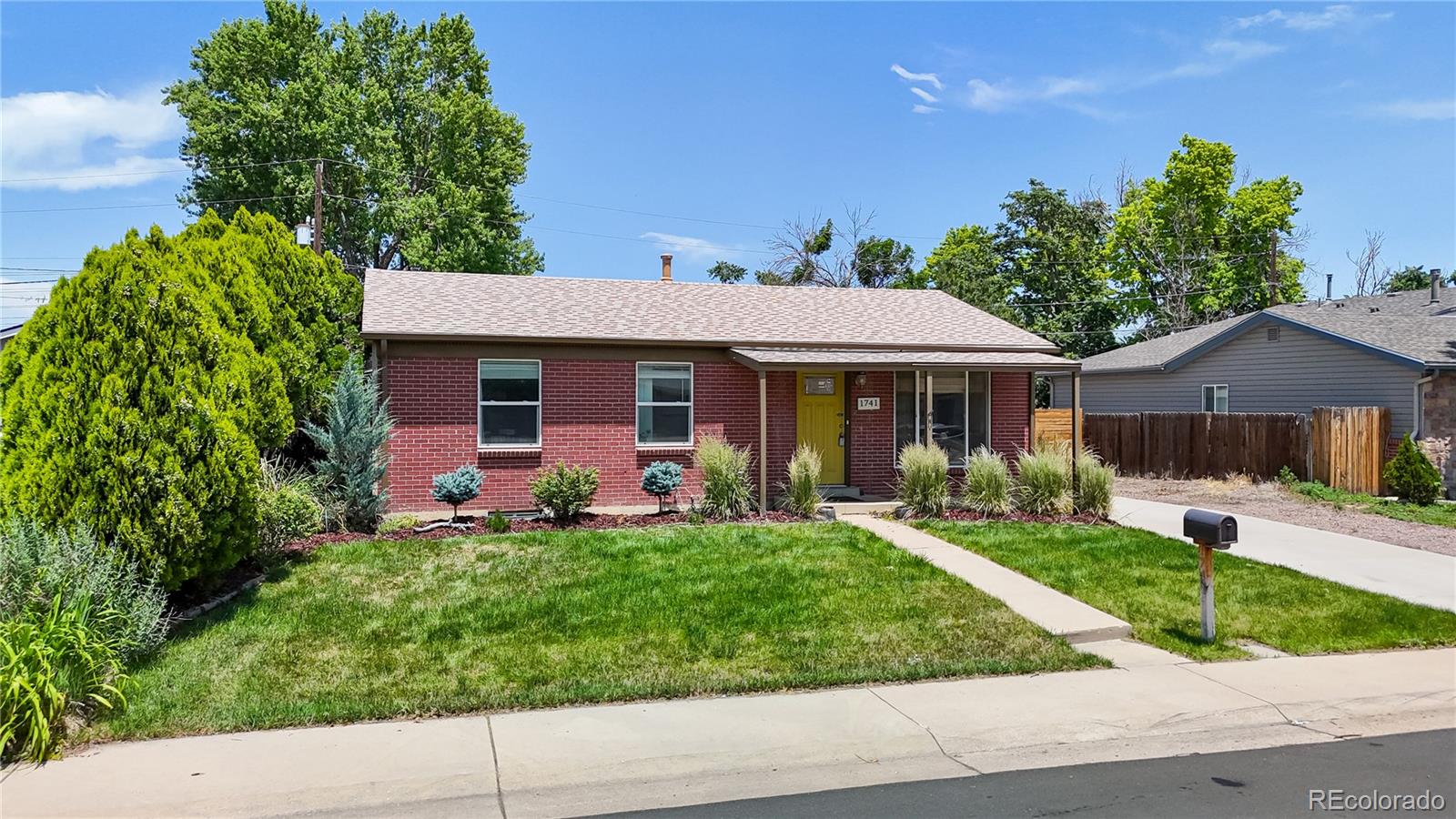 1741 West 55th Place Denver, CO 80221 - Photo 28 of 36 front view of a house with a yard