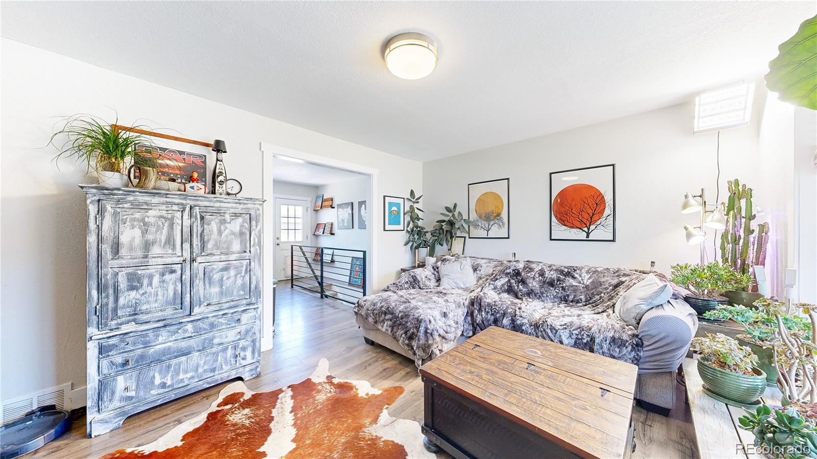 1741 West 55th Place Denver, CO 80221 - Photo 3 of 36 a living room with furniture and wooden floor