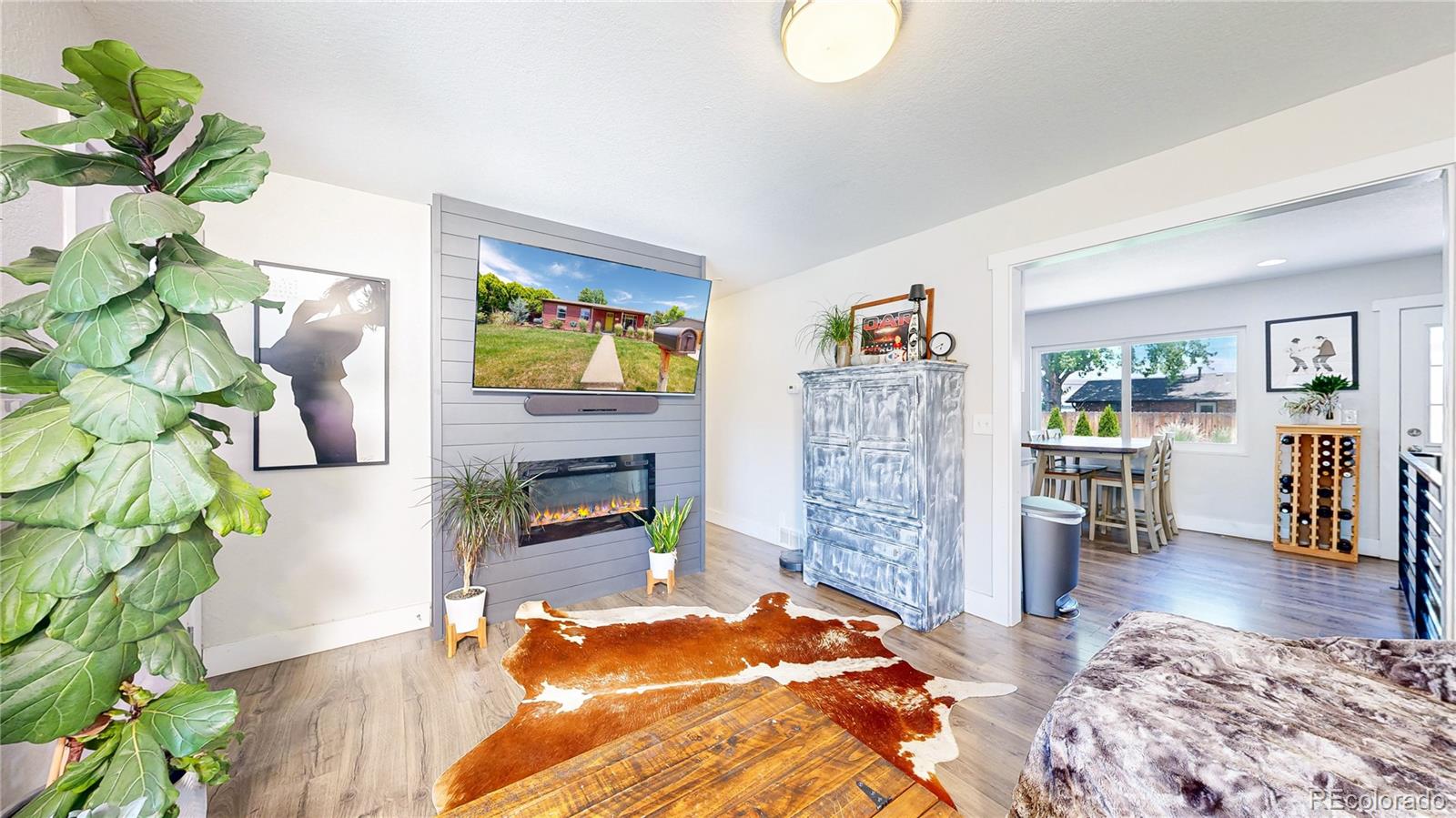 1741 West 55th Place Denver, CO 80221 - Photo 4 of 36 a living room with fireplace furniture and a wooden floor