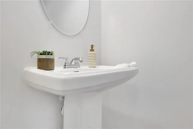 a spacious bedroom with a bed and painting on the wall