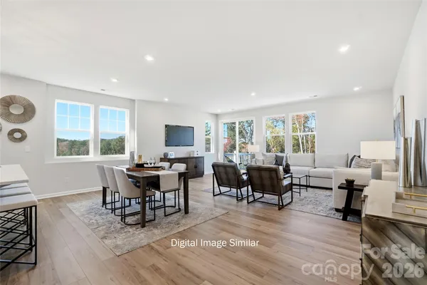 a living room with furniture a large window and a table