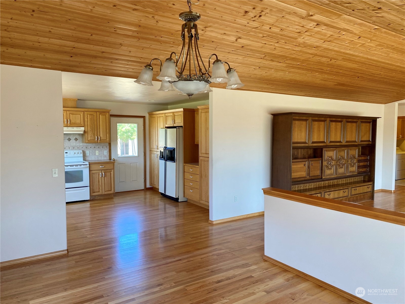 130 Cline Road Sequim, WA 98382 - Photo 11 of 35 a view of hallway with granite countertop stainless steel appliances and wooden floor
