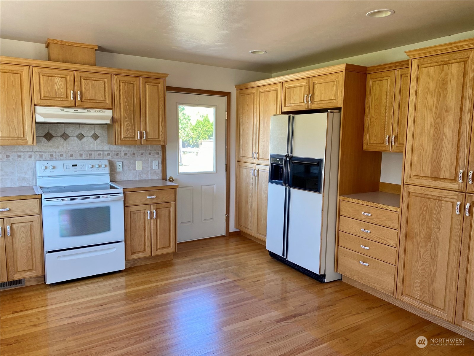 130 Cline Road Sequim, WA 98382 - Photo 14 of 35 a kitchen with a refrigerator and cabinets