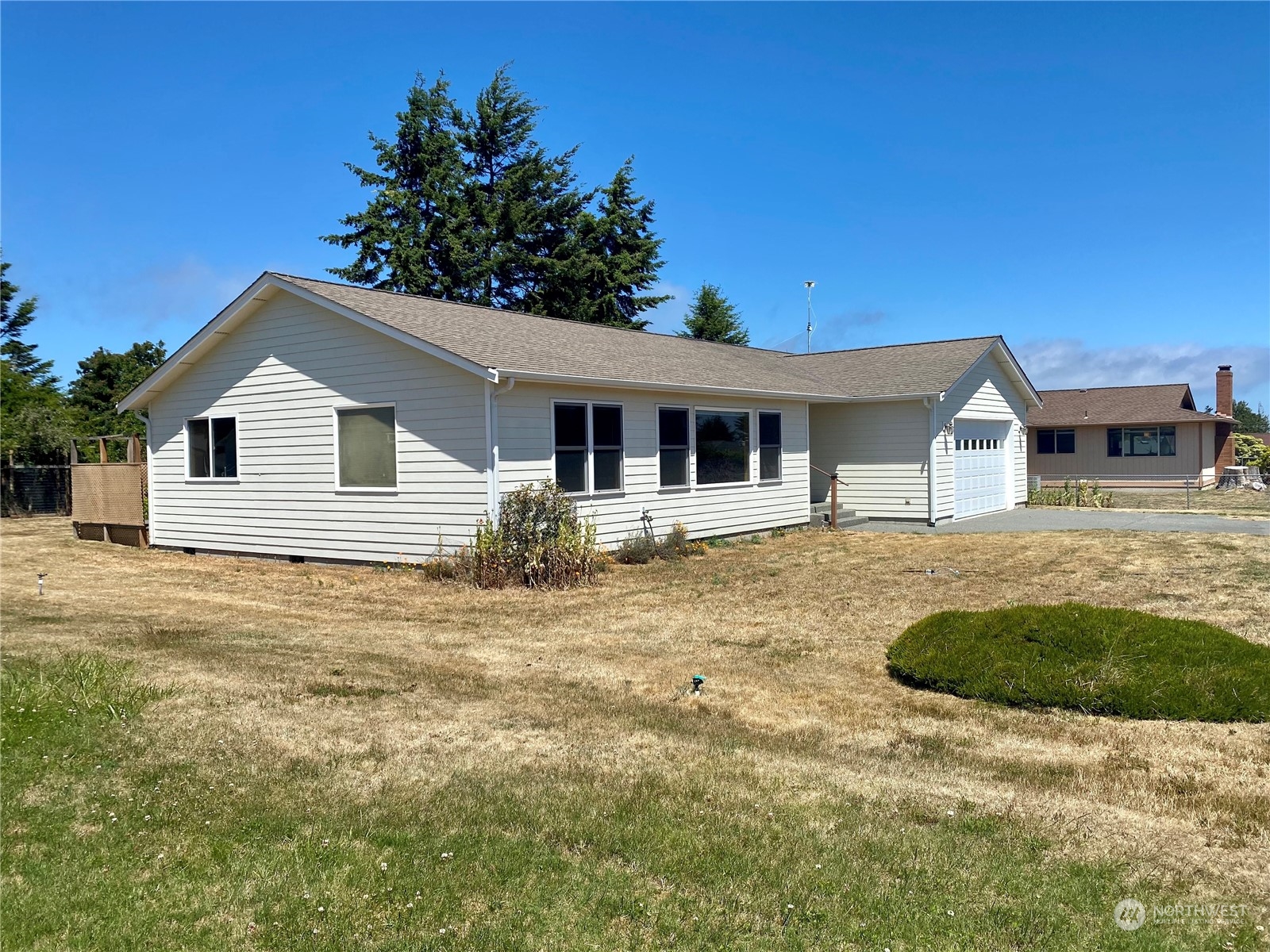130 Cline Road Sequim, WA 98382 - Photo 2 of 35 a front view of a house with a garden