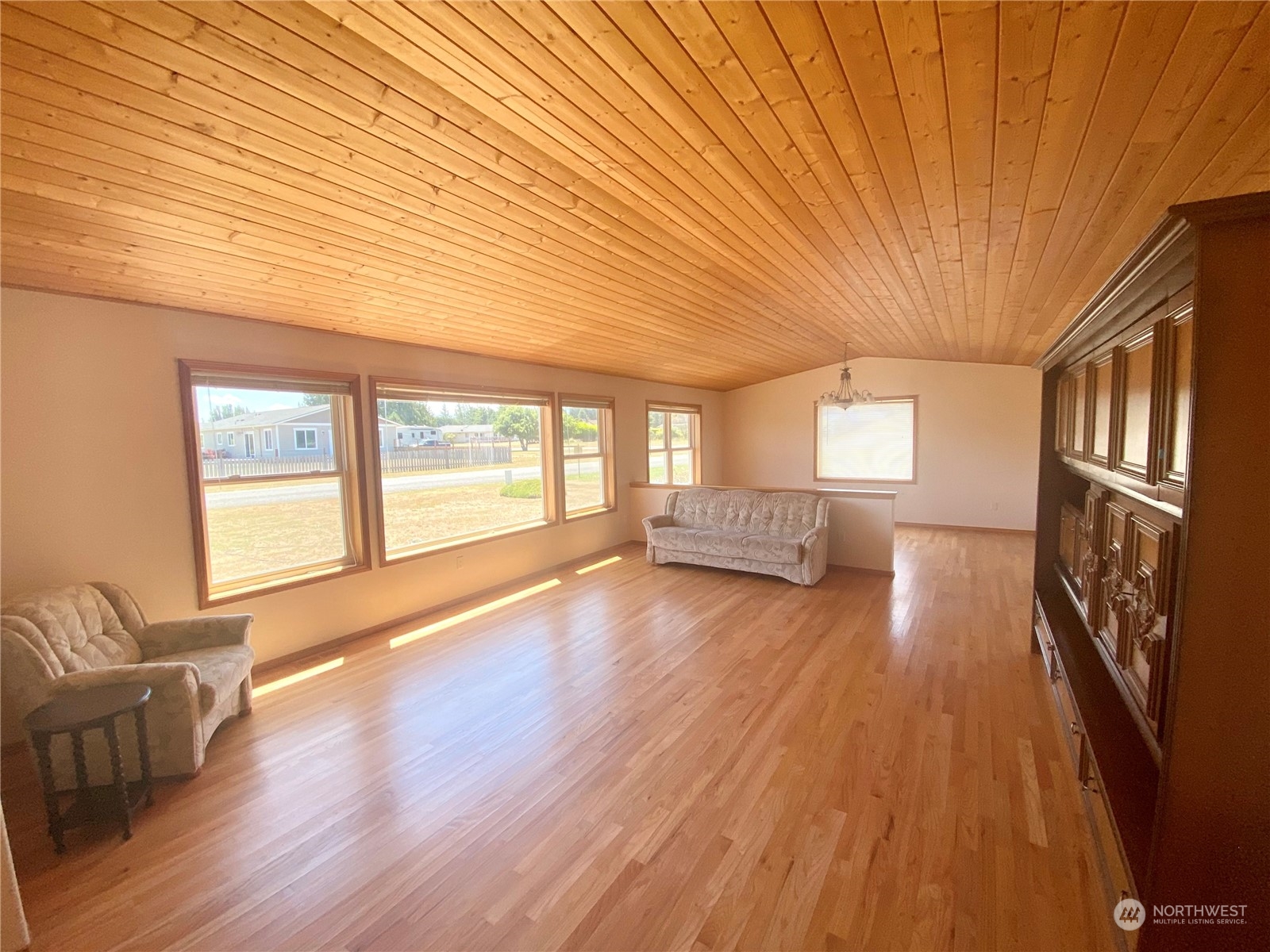130 Cline Road Sequim, WA 98382 - Photo 9 of 35 a view of an empty room with wooden floor and a window