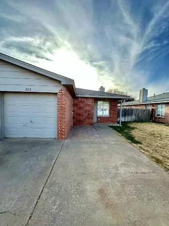 a view of a house with a yard and garage