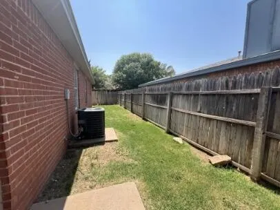 a view of a backyard with wooden fence
