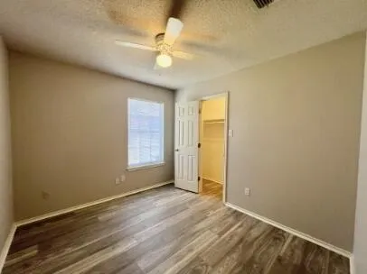 an empty room with a empty space and a ceiling fan