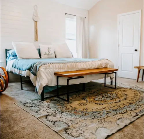 a living room with a couch and a rug