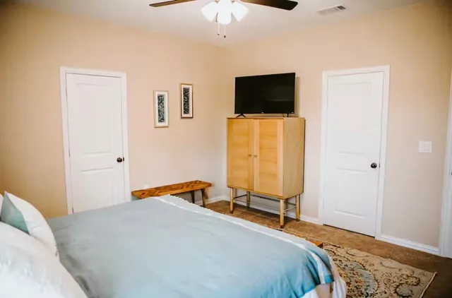a bedroom with a bed and a flat screen tv