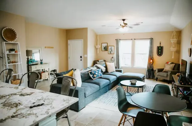a living room with furniture and wooden floor