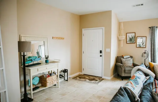 a bedroom with furniture and a mirror