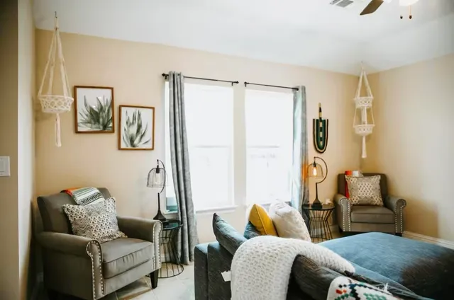 a living room with furniture and a large window