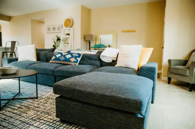 a living room with furniture and wooden floor