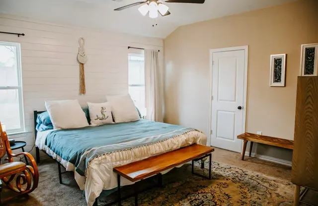 a bedroom with a bed and a chandelier
