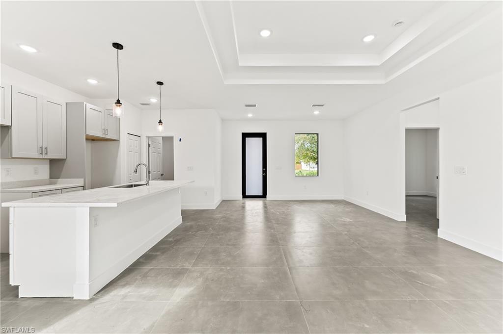 3705 37th Street Southwest Lehigh Acres, FL 33976 - Photo 11 of 35 a large white kitchen with lots of counter space and window