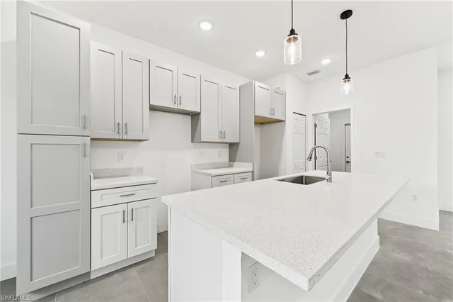 a kitchen with kitchen island white cabinets and white appliances