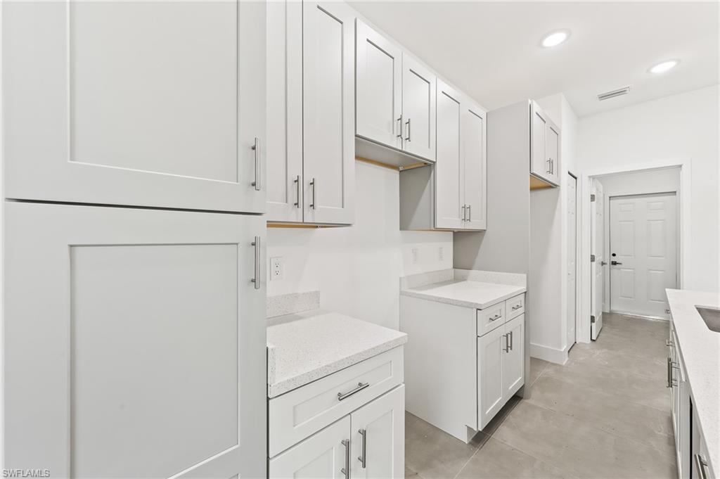 3705 37th Street Southwest Lehigh Acres, FL 33976 - Photo 16 of 35 a view of a kitchen with white cabinets