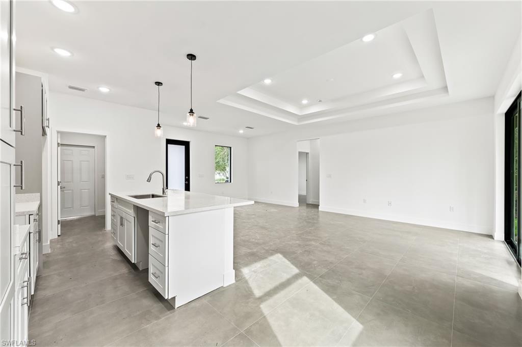 3705 37th Street Southwest Lehigh Acres, FL 33976 - Photo 20 of 35 a large white kitchen with a sink and stainless steel appliances