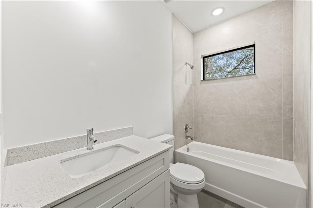 3705 37th Street Southwest Lehigh Acres, FL 33976 - Photo 29 of 35 a bathroom with a sink toilet and a bathtub
