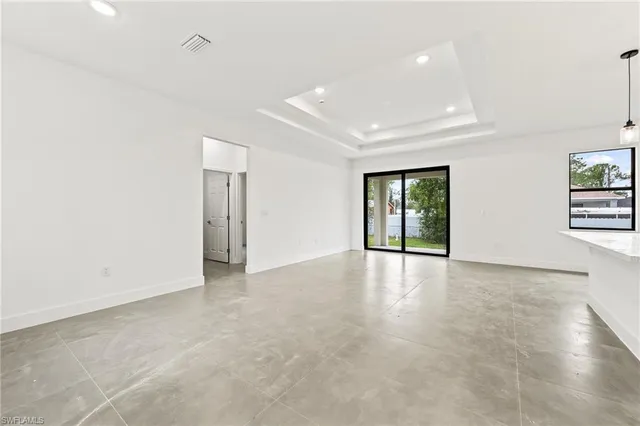 an empty room with windows and entrance