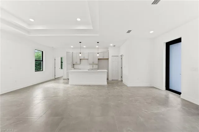 a view of a livingroom with kitchen and furniture