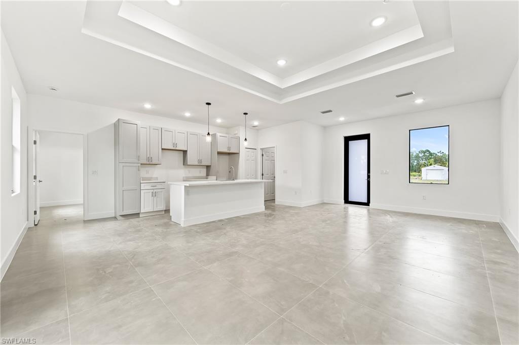 3705 37th Street Southwest Lehigh Acres, FL 33976 - Photo 9 of 35 a view of a kitchen with refrigerator and windows