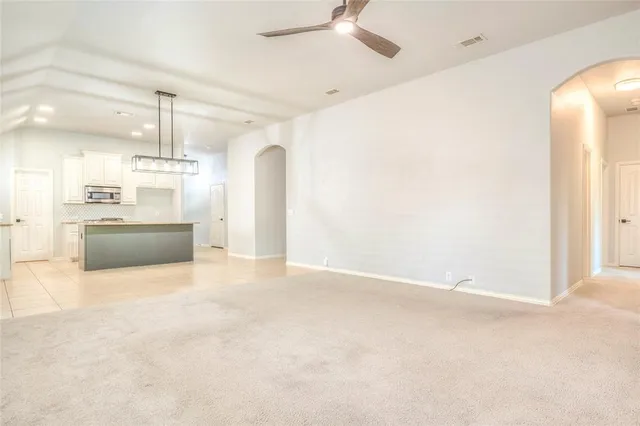 a view of a kitchen with a sink and a refrigerator