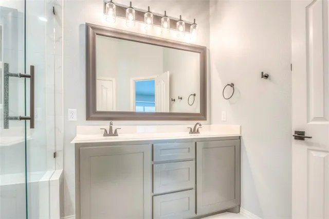 a bathroom with a double vanity sink and mirror