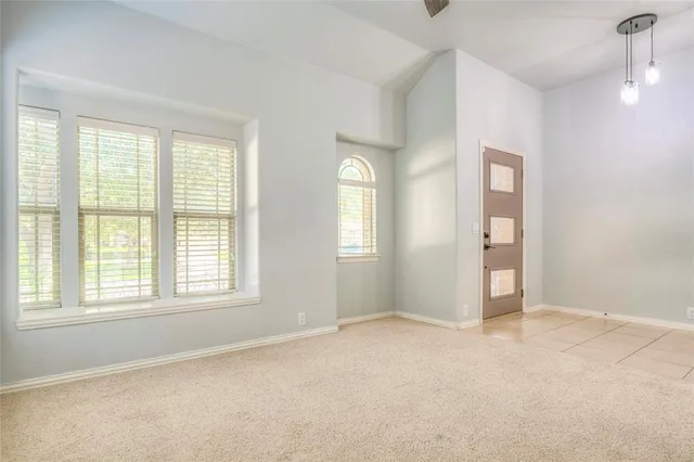 an empty room with windows and closet