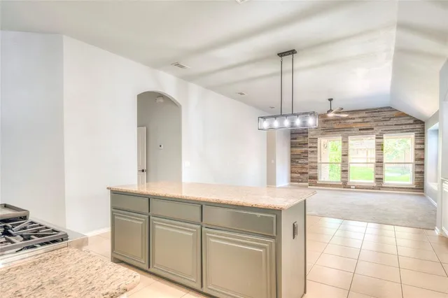 a spacious bathroom with a granite countertop sink a mirror and a bathtub