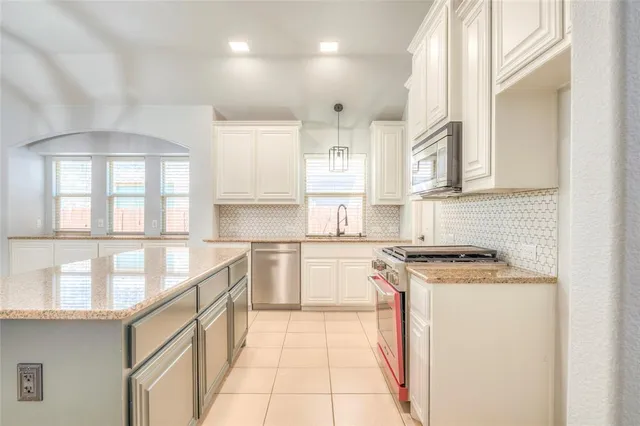 a kitchen with a stove a sink and a refrigerator