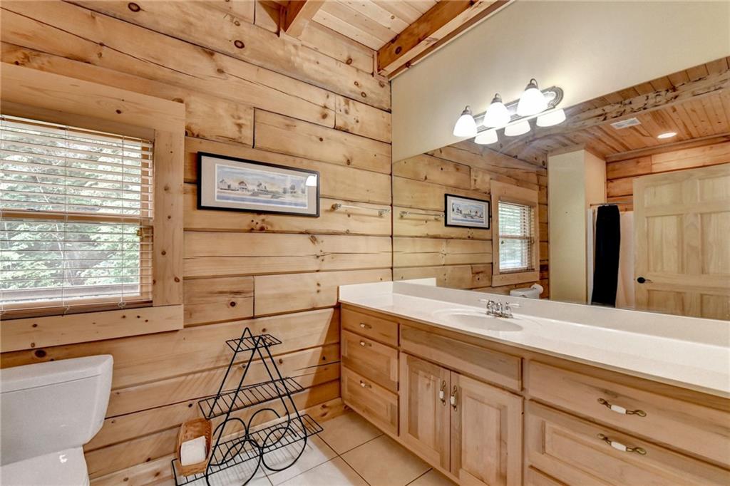 82 Walnut Grove Lane Tiger, GA 30576 - Photo 42 of 88 a bathroom with a sink a large mirror and a shower