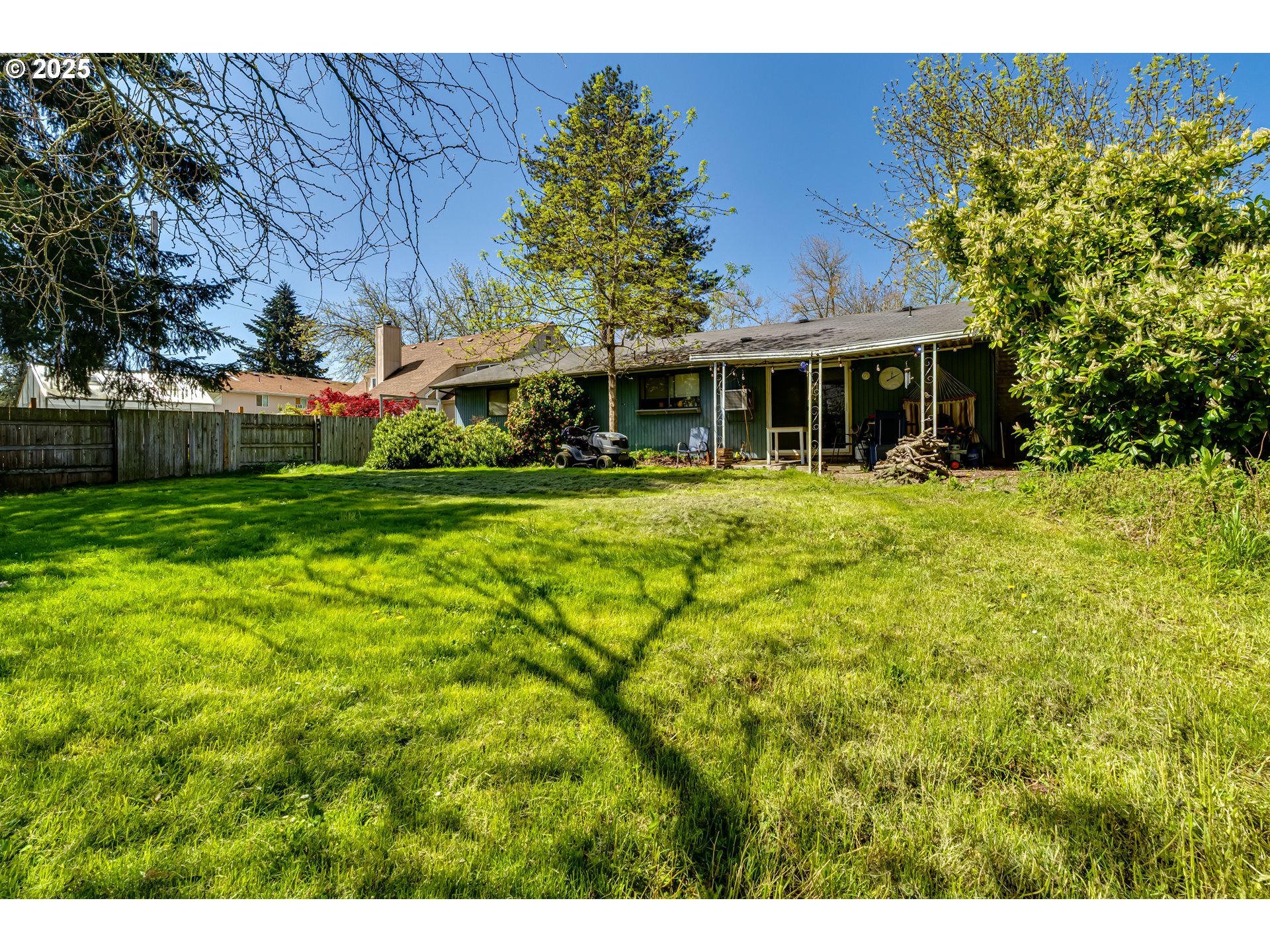 3911 Pam Street Eugene, OR 97402 - Photo 22 of 25 a view of a house with a big yard and large trees