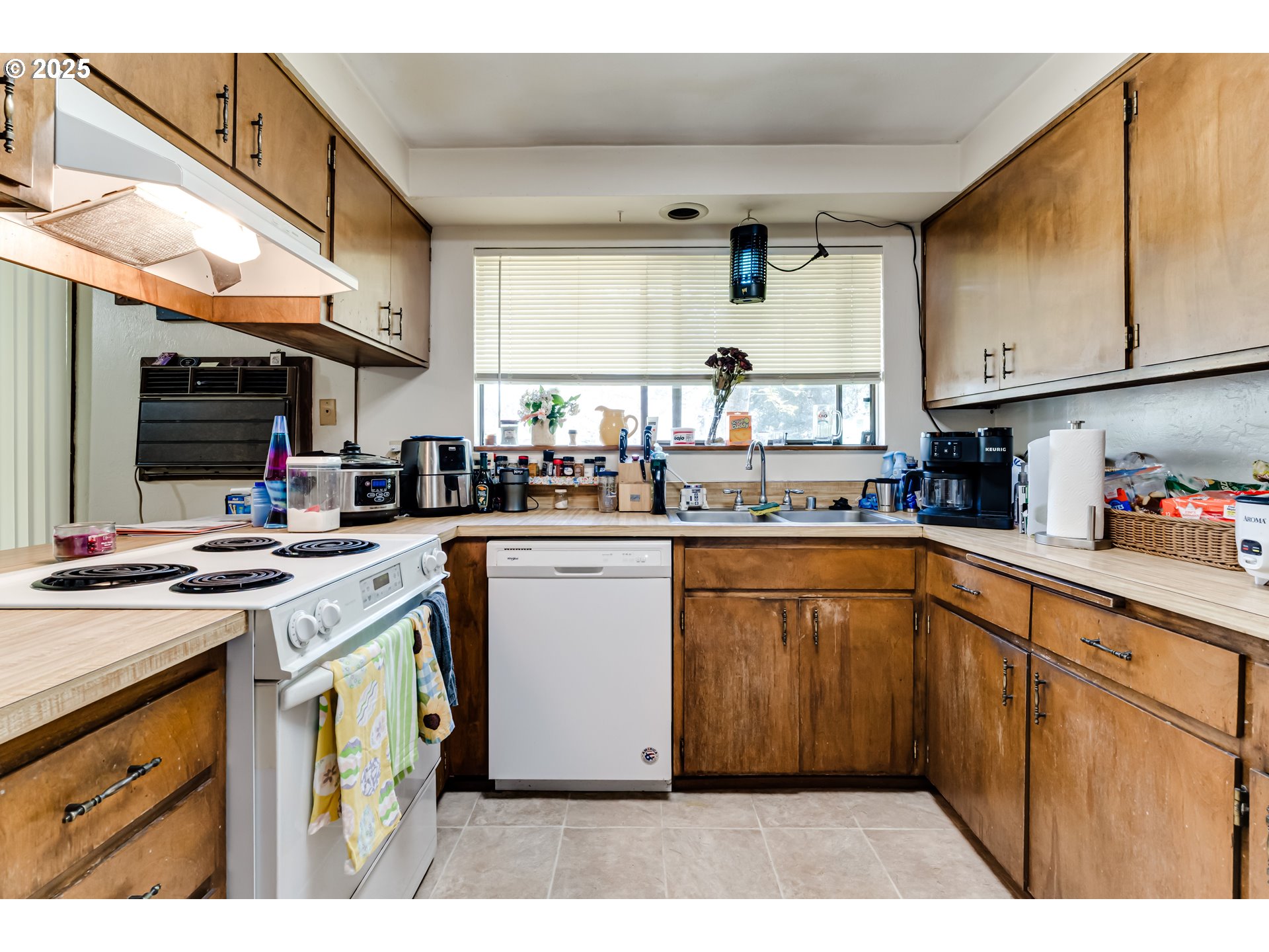 3911 Pam Street Eugene, OR 97402 - Photo 9 of 25 a kitchen with stainless steel appliances granite countertop a stove a sink dishwasher and cabinets with wooden floor
