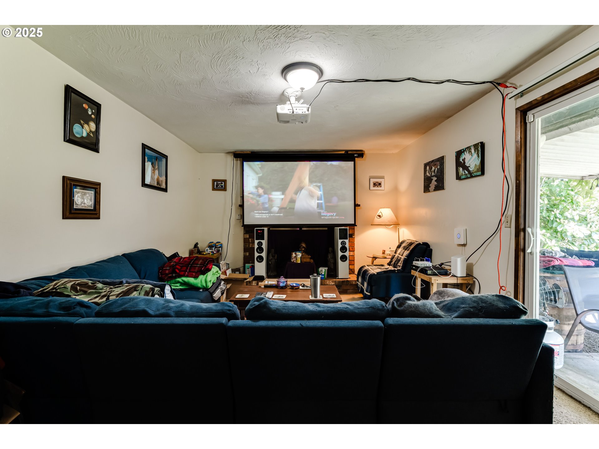 3911 Pam Street Eugene, OR 97402 - Photo 10 of 25 a living room with furniture a fireplace and a flat screen tv